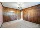 Spacious bedroom featuring paneled walls, plush carpeting, and closet for ample storage at 13909 Idlewild Rd, Matthews, NC 28105
