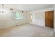 Bright bedroom with neutral carpet, closet, and large window that provides ample sunlight at 13909 Idlewild Rd, Matthews, NC 28105