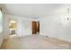 Bright bedroom with neutral carpet, closet, and adjacent bathroom featuring double sinks at 13909 Idlewild Rd, Matthews, NC 28105