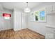 Bright bedroom with wood laminate flooring, built-in cabinets, shuttered windows and a door to the exterior at 13909 Idlewild Rd, Matthews, NC 28105