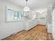 Bright kitchen with laminate floors, and white cabinets, with natural light from large windows, a cozy culinary space at 13909 Idlewild Rd, Matthews, NC 28105