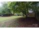 Spacious backyard with mature trees and storage shed at 1409 Turner Dr, Gastonia, NC 28052