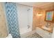 Bathroom with shower and tub, floral wallpaper, vanity, and framed mirror at 1409 Turner Dr, Gastonia, NC 28052