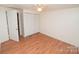 Cozy bedroom featuring vinyl floors, paneled walls, ceiling fan, and closet at 1409 Turner Dr, Gastonia, NC 28052