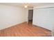 Cozy bedroom featuring vinyl floors, paneled walls, ceiling fan, and closet at 1409 Turner Dr, Gastonia, NC 28052