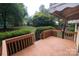 Wooden deck with railings overlooking a green backyard with manicured hedges at 1409 Turner Dr, Gastonia, NC 28052