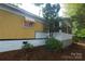 Side view of a well-maintained single-story home with mature landscaping at 1409 Turner Dr, Gastonia, NC 28052