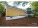 A yellow single-story home with a side door and mature landscaping at 1409 Turner Dr, Gastonia, NC 28052