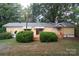 Exterior of home featuring a covered front porch and well-manicured landscaping at 1409 Turner Dr, Gastonia, NC 28052