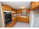 Well-equipped kitchen with wooden cabinets, practical layout, and updated flooring at 1409 Turner Dr, Gastonia, NC 28052