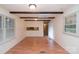 Inviting living area featuring hardwood floors, exposed beam ceiling, and large window at 1409 Turner Dr, Gastonia, NC 28052