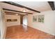 Bright living area with hardwood floors, exposed beam ceiling, and ample natural light at 1409 Turner Dr, Gastonia, NC 28052