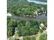 Aerial view of property, displaying the lush surrounding landscape and water access at 143 Uwharrie Ct # 10801081, Mount Gilead, NC 27306
