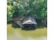 Aerial view of boat house on the water surrounded by trees at 143 Uwharrie Ct # 10801081, Mount Gilead, NC 27306