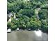 Aerial view showcasing the property's lake access and mature tree coverage at 143 Uwharrie Ct # 10801081, Mount Gilead, NC 27306