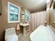 Bathroom with pedestal sink, tile floor, and shower-tub combo at 143 Uwharrie Ct # 10801081, Mount Gilead, NC 27306