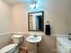 Bathroom with pedestal sink, toilet, and mirror with green trim at 143 Uwharrie Ct # 10801081, Mount Gilead, NC 27306