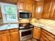 Modern kitchen featuring wood cabinets, granite countertops, stainless steel appliances, and updated features at 143 Uwharrie Ct # 10801081, Mount Gilead, NC 27306