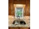 Granite countertops surround a stainless steel double sink beneath a window at 143 Uwharrie Ct # 10801081, Mount Gilead, NC 27306