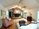 Inviting living room featuring a stone fireplace, vaulted ceilings, and hardwood floors for a cozy atmosphere at 143 Uwharrie Ct # 10801081, Mount Gilead, NC 27306