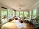 Light-filled sunroom surrounded by windows, offering peaceful views of the outdoors and a relaxing retreat at 143 Uwharrie Ct # 10801081, Mount Gilead, NC 27306