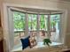 Bright bay window with white trim, pillows and wooded lake view at 143 Uwharrie Ct # 10801081, Mount Gilead, NC 27306