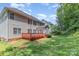 View of the spacious backyard, wood deck, and exterior of the home at 14333 Maclauren Ln, Huntersville, NC 28078