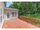 Outdoor deck with red railings that looks out on trees and an adjacent building at 14333 Maclauren Ln, Huntersville, NC 28078