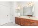 Bathroom with double sinks, granite counters, with a large mirror and white doors at 14333 Maclauren Ln, Huntersville, NC 28078