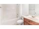 Bathroom featuring a combined bathtub and shower, and a vanity sink, and white tiling at 14333 Maclauren Ln, Huntersville, NC 28078