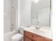 Bathroom featuring a combined bathtub and shower, vanity sink, and a white door at 14333 Maclauren Ln, Huntersville, NC 28078