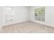 Well-lit carpeted bedroom with two windows, offering a bright and airy atmosphere at 14333 Maclauren Ln, Huntersville, NC 28078
