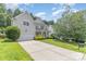 Spacious home featuring a long driveway, attached garage, and well-maintained lawn, perfect for families and entertaining at 14333 Maclauren Ln, Huntersville, NC 28078