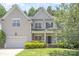Charming two-story home featuring a manicured front yard, attached garage, and classic architectural details at 14333 Maclauren Ln, Huntersville, NC 28078