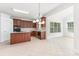 Open kitchen featuring wooden cabinets, a kitchen island, modern appliances, and tile flooring offers form and functionality at 14333 Maclauren Ln, Huntersville, NC 28078