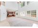 Open-concept living area with abundant natural light, seamlessly connecting to a kitchen with wooden cabinets and tile floors at 14333 Maclauren Ln, Huntersville, NC 28078
