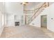 Bright living room with a cozy fireplace, built-in shelving, a staircase, and plush carpeting offers a relaxing atmosphere at 14333 Maclauren Ln, Huntersville, NC 28078
