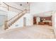 Open-concept living room features a soaring ceiling, a staircase, and seamless flow into the kitchen, great for entertaining at 14333 Maclauren Ln, Huntersville, NC 28078