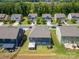Aerial view of a residential neighborhood with well-maintained homes, green lawns, and tree-lined streets at 15119 Oleander Dr, Charlotte, NC 28278