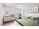 Staged bedroom with modern decor, large window, and a comfortable bed dressed with soft pillows and linens at 15119 Oleander Dr, Charlotte, NC 28278