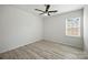 Bedroom showcasing a ceiling fan, window, and light-colored flooring at 15119 Oleander Dr, Charlotte, NC 28278