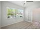 Bright, airy bedroom with large windows, wood-look floors, and a door to an adjacent room at 15119 Oleander Dr, Charlotte, NC 28278