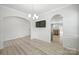 Open-concept dining area featuring a modern chandelier, wainscoting, and seamless flow to other living spaces at 15119 Oleander Dr, Charlotte, NC 28278