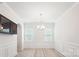 Empty dining room space with a modern light fixture and plenty of natural light at 15119 Oleander Dr, Charlotte, NC 28278
