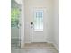 Bright entryway featuring a stylish front door with glass panels and durable hardwood flooring at 15119 Oleander Dr, Charlotte, NC 28278