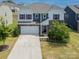 Daytime view of a beautiful two-story home with stone accents, an attached garage, and a well-maintained lawn at 15119 Oleander Dr, Charlotte, NC 28278