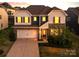 Inviting two-story home with a well-manicured lawn, attached garage, and stone and siding details at 15119 Oleander Dr, Charlotte, NC 28278