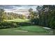 Picturesque golf course view with lush green fairways and mature trees, offering a serene and scenic landscape at 15119 Oleander Dr, Charlotte, NC 28278