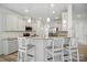 Bright kitchen features white cabinets, stainless steel appliances, granite counters, and seating at the breakfast bar at 15119 Oleander Dr, Charlotte, NC 28278