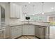 The kitchen features stainless appliances, granite counters, a subway tile backsplash, and white cabinetry at 15119 Oleander Dr, Charlotte, NC 28278